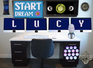 A desk with multiple computer monitors spelling out LUCY and a robotic head on the desk. This is the LUCY console.