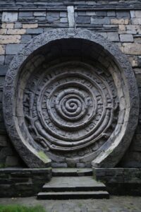 A stone circular type carving that spirals on the inside with a lot of mystical looking markings on it. Their are steps leading to the centre of the spiral.