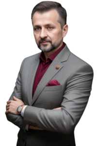 Oleg Travlofkosky, a well dressed man in a grey suite with a dark coloured shirt. He has short hair and a goatee.